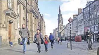  ??  ?? EDINBURGH: A family walks down a street in Edinburgh, Scotland. Scotland’s leader delivered a shock twist to Britain’s EU exit drama on Monday, announcing that she will seek authority to hold a new independen­ce referendum in the next two years because...
