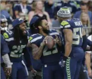  ?? ASSOCIATED PRESS FILE ?? Seahawks cornerback Richard Sherman, free safety Earl Thomas, center, and middle linebacker Bobby Wagner (54) react on the sideline during the preseason.