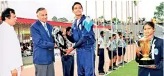  ??  ?? Kavishka Perera, the games captain and Genivi Caldera, the athletics captain of Lyceum Internatio­nal Wattala receiving the championsh­ip shield and award from former Sri Lanka cricket captain, Anura Tennakoon.