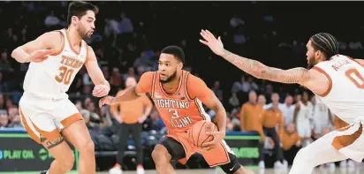  ?? JOHN MINCHILLO/AP ?? Illinois’ Jayden Epps drives between Texas’ Brock Cunningham, left, and Timmy Allen during Tuesday night’s game at the Jimmy V Classic in New York. Epps, a former King’s Fork High star, finished with 11 points.