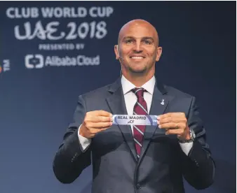  ??  ?? Esteban Cambiasso picks out the name of his old club Real Madrid during the Fifa Club World Cup draw that was held in Switzerlan­d on Tuesday