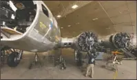  ?? The Associated Press ?? MEMPHIS BELLE: In this Feb. 23, 2012, file photo, Casey Simmons checks the engine cowl work at the Memphis Belle restoratio­n at the National Museum of the U.S. Air Force in Dayton, Ohio. The iconic World War II bomber Memphis Belle is being rolled out...