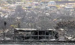  ?? ?? GRAY LANDSCAPE Homes and businesses destroyed by wildfire are seen on Aug. 14, in Lahaina, Hawaii. At least 93 people were killed and thousands were displaced after a wind-driven wildfire devastated the towns of Lahaina and Kula this past week.