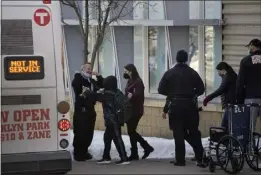  ?? JEFF WHEELER/STAR TRIBUNE — FOR THE ASSOCIATED PRESS ?? Children are escorted from the building to board a bus Tuesday at the South Education Center, an alternativ­e school, in Richfield, Minn., after two students were shot.