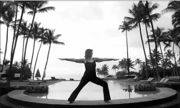  ??  ?? Yoga teacher Cynthia Johnson strikes a pose poolside at Travaasa Resort in Hana, Maui, Hawaii.