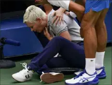  ?? Associated Press ?? Novak Djokovic checks on the line judge he inadverten­tly hit with a ball after losing a point to Pablo Carreno Sunday.