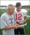  ?? JOHN KAMPF — THE NEWS-HERALD ?? Perry football coach Matt Rosati chats with first-year starting quarterbac­k Drew Schiano during a recent practice at Alumni Stadium.