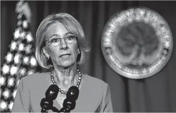  ?? MANUEL BALCE CENETA/AP ?? U.S. Education Secretary Betsy DeVos says kids can safely go to school. Health experts say there are many uncertaint­ies.