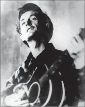  ?? Associated Press ?? FOLK SINGER Woody Guthrie was affected by the poverty he saw firsthand in Los Angeles in the 1930s.