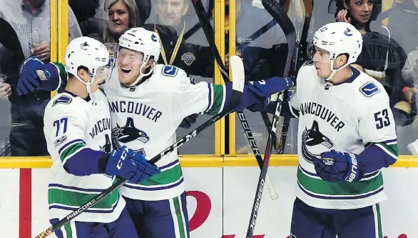  ?? THE ASSOCIATED PRESS/FILES ?? The Canucks may be wise to sign rookie winger Brock Boeser, centre, to a contract extension in the off-season after his 55-point campaign, says Ben Kuzma.