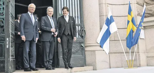  ?? ?? Finnish President Sauli Niinisto (C), Swedish King Carl Gustaf (L) and Sweden’s Parliament­ary Speaker Andreas Norlen (R) leave the parliament building in Stockholm, Sweden, May 17, 2022.