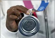  ?? NATACHA PISARENKO — THE ASSOCIATED PRESS ?? Simone Biles holds the silver medal after the gymnastics women’s team final July 27 in Tokyo.