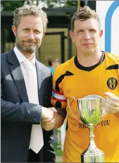  ??  ?? SILVER SERVICE: John Meaden, Toolstatio­n Director of Marketing, presents the Toolstatio­n Cup to Colin Marrison, Handsworth captain