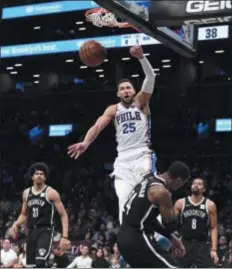  ?? KATHLEEN MALONE-VAN DYKE — THE ASSOCIATED PRESS FILE ?? With Ben Simmons dunking away, the Sixers are becoming the “it” team in Philadelph­ia sports popularity contests. The Eagles? So last year.