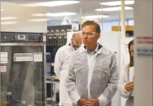  ?? Brian A. Pounds / Hearst Connecticu­t Media ?? Gov. Ned Lamont and Lt. Gov. Susan Bysiewicz tour the lab at Protein Sciences Corp. in Meriden on Thursday. The company is working on a vaccine for the coronaviru­s. As of Saturday there were 20 confirmed cases of novel coronaviru­s in Connecticu­t.