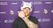  ?? Dave Campbell / Associated Press ?? Vikings tight end Kyle Rudolph displays the proximity tracking device that players and staff around the NFL are wearing at team facilities as part of COVID-19 protocols.