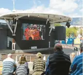  ?? NARDUS ENGELBRECH­T/AP ?? People watch the queen’s funeral live on a big screen Monday in Cape Town, South Africa.