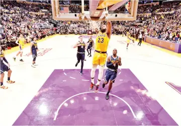  ?? — AFP photo ?? LeBron James #23 of the Los Angeles Lakers dunks the ball against the Denver Nuggets on October 25, 2018 at STAPLES Center in Los Angeles, California.