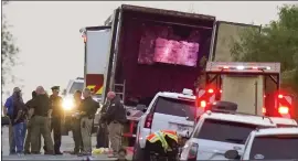  ?? ERIC GAY — THE ASSOCIATED PRESS ?? Police and other first responders work the scene where officials say dozens of people were found dead and multiple others were taken to hospitals after a truck containing suspected migrants was found Monday in San Antonio. The death toll is up to 53.