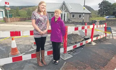  ??  ?? Left, Kelly and Isla show the distance between the exchange and the hall.
Above, work has started at last.