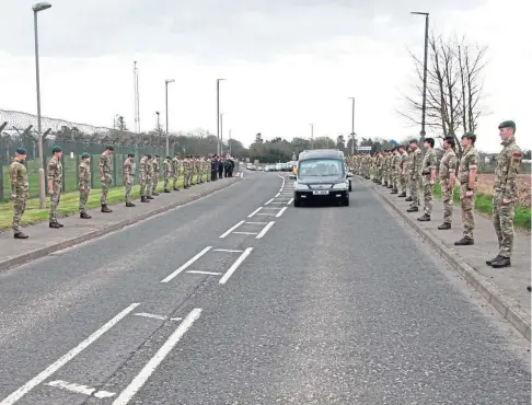  ??  ?? FINAL JOURNEY: Royal Marines of 45 Commando pay their respects to James ‘Pip’ Meek with a guard of honour.