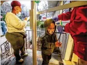  ?? STEVE SCHAEFER FOR THE AJC ?? Ashley Strickland takes the temperatur­e of Aiden Daniels, 5, as his mother, Aoctavis Joyner, fills out a form at the Little Ones Learning Center in Forest Park.