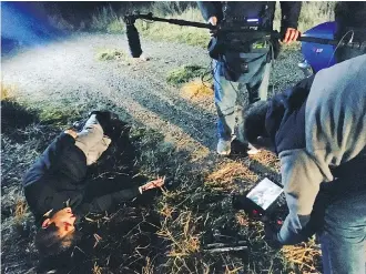  ??  ?? Director of Photograph­er Nate Harper shoots scenes for the Zodiac episode of The Shocking Truth at Ghost Lake, near Cochrane.