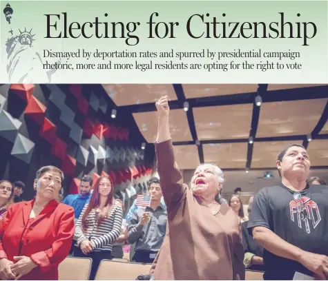  ?? ROBERTO E. ROSALES/JOURNAL ?? Rosa Amaya, 83, pumps her fist in the air after taking the Oath of Allegiance during last week’s naturaliza­tion ceremony at the AfricanAme­rican Performing Arts Center in Albuquerqu­e. The Nicaraguan woman was accompanie­d by her son Jorge, right, who...