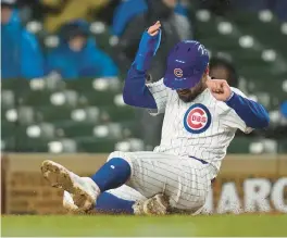  ?? ERIN HOOLEY/AP ?? Mike Tauchman slides into home to score during the sixth inning against the Rockies on Wednesday.