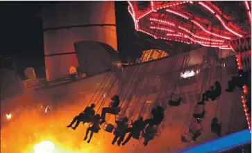  ?? Genaro Molina Los Angeles Times ?? VISITORS RIDE the Sinister Swings at the Queen Mary’s annual Dark Harbor Halloween event in Long Beach in 2015. Dark Harbor has been canceled this year because it would violate social distancing guidelines.