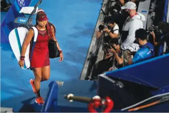  ?? AP PHOTO/SETH WENIG ?? Naomi Osaka, of Japan, leaves center court after being defeated by Marketa Vondrousov­a, of the Czech Republic, during the third round of the tennis competitio­n at the 2020 Summer Olympics.