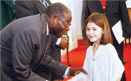  ??  ?? President Mugabe shares a lighter moment with Julia Calltorp, the daughter of incoming Swedish Ambassador to Zimbabwe Sofia Calltorp in Harare yesterday. — (Picture by Justin Mutenda)