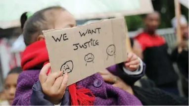  ?? PICTURE: HENK KRUGER/AFRICAN NEWS AGENCY (ANA) ?? ENOUGH: Mitchells Plain residents picket outside the magistrate’s court where Christophe­r Brown, 25, made his first appearance in connection with the murder of 6-year-old Stacey Adams.