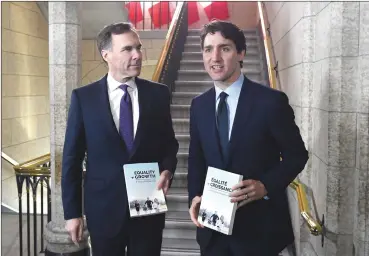  ?? Canadian Press photo ?? Minister of Finance Bill Morneau walks with Prime Minister Justin Trudeau, right, before tabling the budget in the House of Commons on Parliament Hill in Ottawa on Tuesday.