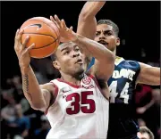  ?? NWA Democrat-Gazette/J.T. WAMPLER ?? Arkansas freshman forward Reggie Chaney goes up for a shot as Garrison Goode of Cal-Davis defends during the first half.