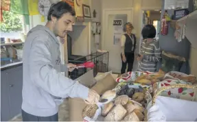  ??  ?? Queenstown's Happiness House members sort through some donated bread which they will give to the local community.