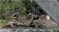  ?? GETTY IMAGES ?? Trainees simulate a rescue during a combat care exercise in New Taipei City, Taiwan.