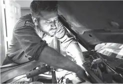  ?? Associated Press ?? BELOW and RIGHT: Mechanic Chris Geropoulos works a on car on July 5 at Ted’s Auto Clinic in Chicago.