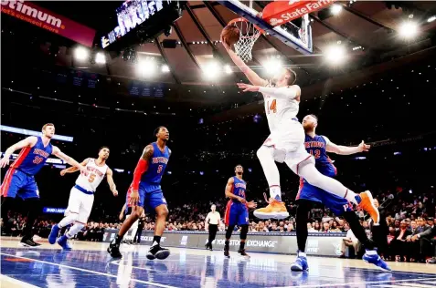  ?? (AP Photo/Julie Jacobson) ?? New York Knicks center Willy Hernangome­z (14) puts up a reverse layup against the Detroit Pistons during the third quarter of an NBA basketball game, Monday, March 27, 2017, in New York. The Knicks won 109-95.