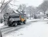  ?? PAUL EISENBERG/DAILY SOUTHTOWN ?? A salt spreader treats a side street in Homewood on Tuesday as the area received its first measurable snow of the season.