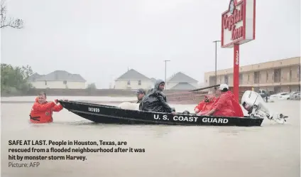  ?? Picture: AFP ?? SAFE AT LAST. People in Houston, Texas, are rescued from a flooded neighbourh­ood after it was hit by monster storm Harvey.