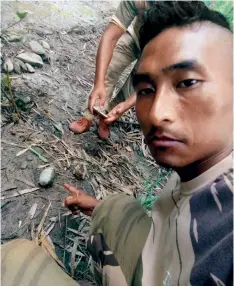  ??  ?? DANGER AHEAD A soldier points to a live grenade at the June 17 Mon ambush site