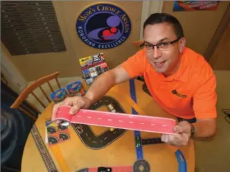  ?? LLOYD FOX, BALTIMORE SUN ?? Andy Musliner, CEO of InRoad, invented PlayTape, paper tape that resembles roads or rails that kids can stick on flat surfaces to create roadways for toy cars.