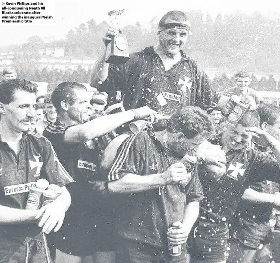  ??  ?? > Kevin Phillips and his all-conquering Neath All Blacks celebrate after winning the inaugural Welsh Premiershi­p title