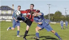  ??  ?? Andy Williams of Bro Goronwy (stripes) lifts the ball over a defender before netting his fifth goal