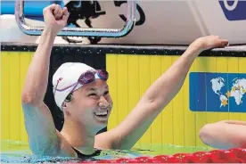  ?? ASSOCIATED PRESS FILE PHOTO ?? Maggie MacNeil reacts after winning the women’s 100-metre butterfly final for Canada on Monday. Knocking off the Olympic champion has thrust her into the world spotlight.