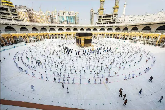  ?? (AP) ?? In this July 31, 2020 file photo, pilgrims walk around the Ka’aba at the Grand Mosque in the Muslim holy city of Makkah. Saudi Arabia said June 12, 2021, that this year’s Hajj pilgrimage will be limited to no more than 60,000 people, all of them from within the kingdom, due to the ongoing coronaviru­s pandemic.