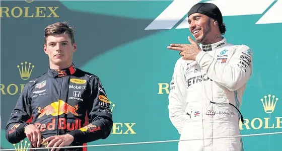  ??  ?? Mercedes’ Lewis Hamilton, right, celebrates a win next to Red Bull’s Max Verstappen last year.