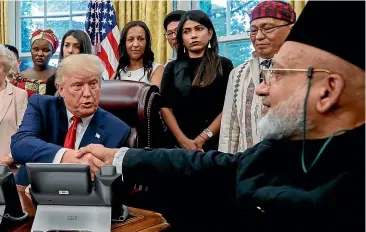  ?? AP ?? United States President Donald Trump shakes hands with Farid Ahmed, a Muslim from Christchur­ch, as he meets with survivors of religious persecutio­n.