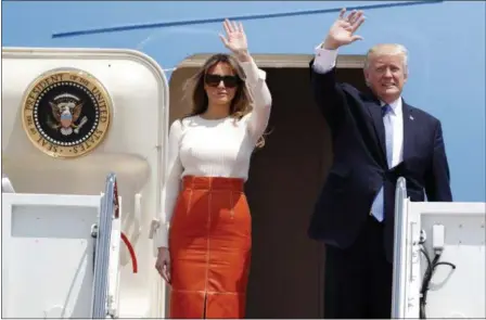  ?? ALEX BRANDON — THE ASSOCIATED PRESS ?? President Donald Trump and first lady Melania Trump, wave as they board Air Force One at Andrews Air Force Base, Md., Friday prior to his departure on his first overseas trip.